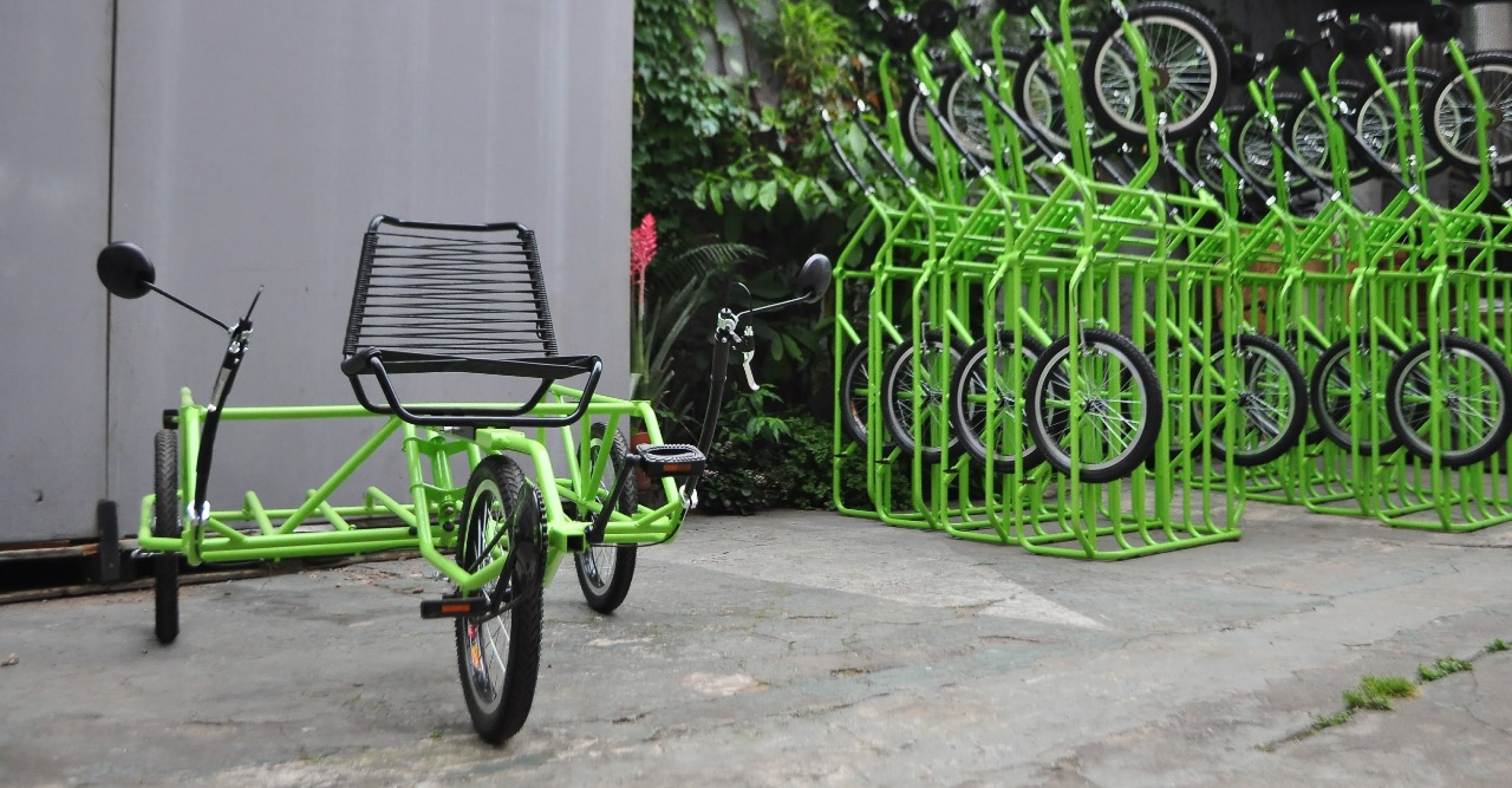 Finished Torky cargo tricycle with a row of production units in the workshop yard